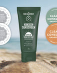 Green sunscreen tube with awards on a beach background. SPF30 Sunscreen from The Nude Alchemist Wins Best Kids Sunscreen and Best Children's Sunscreen